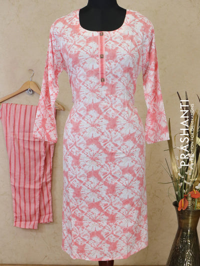 Slub cotton readymade kurti off white and red shade with allover batik prints simple neck work and straight cut pant