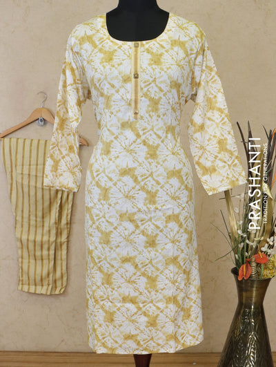 Slub cotton readymade kurti off white and mustard with allover batik prints simple neck work and straight cut pant